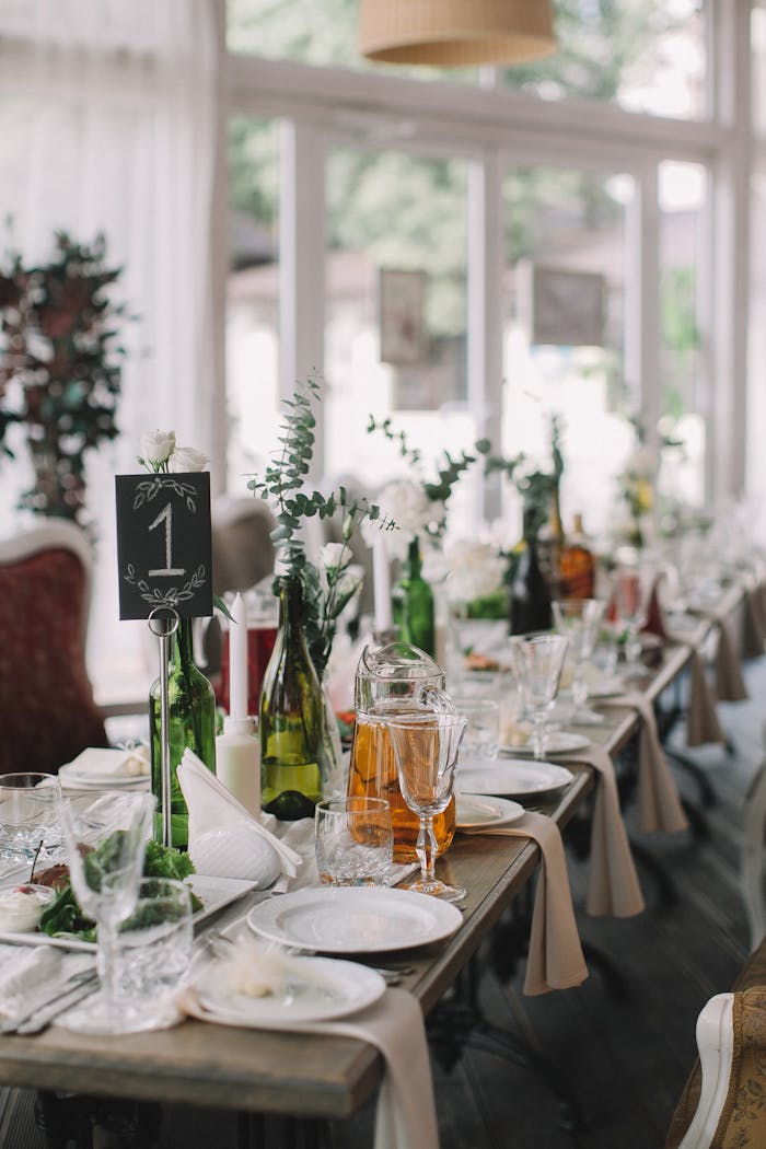 Chic dining setup with elegant tableware and floral decor.